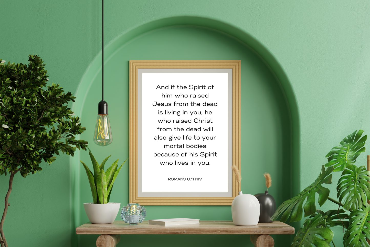 Romans 8:11 Bible verse printable wall art displayed in a modern living room with natural light and plants and boho decor.