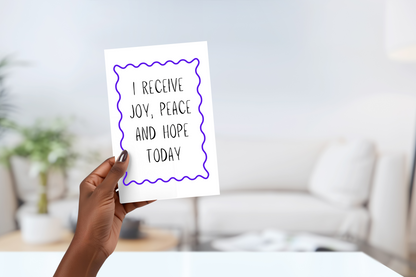 Hand holding an affirmation card with the caption 'I receive joy, peace, and hope today'