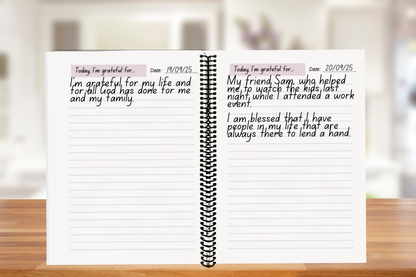 Faith-based Daily Gratitude Journal open on a a wooden table — A4 coiled-bound journal for mindfulness and thankfulness.