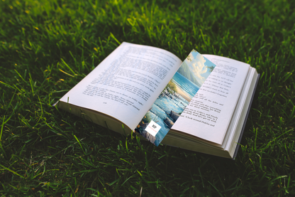 Inspirational “You’re Not Alone – God Walks With You Through Every Battle” bookmark placed inside an open Bible during quiet reading.
