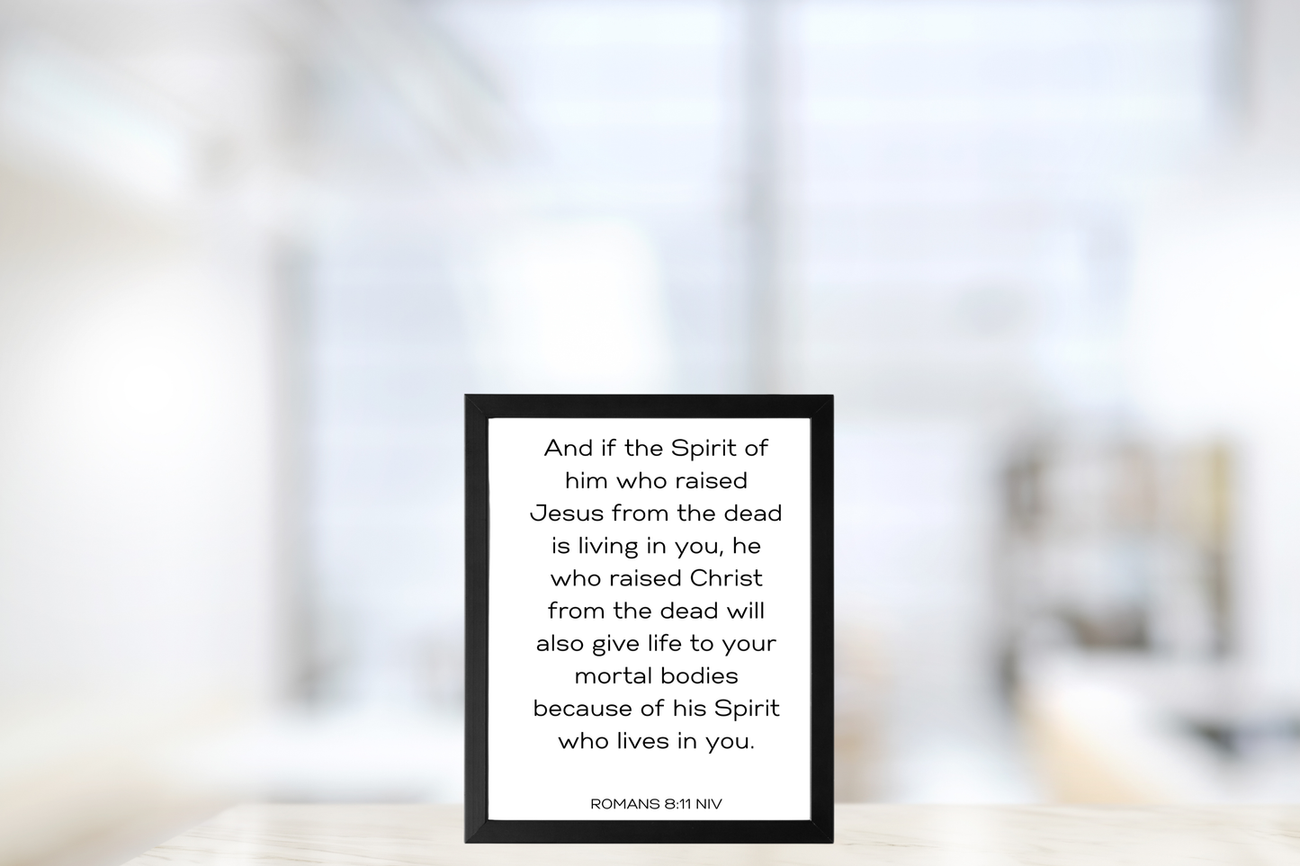 Romans 8:11 Bible verse poster framed in a bright kitchen with subtle minimalist accents.