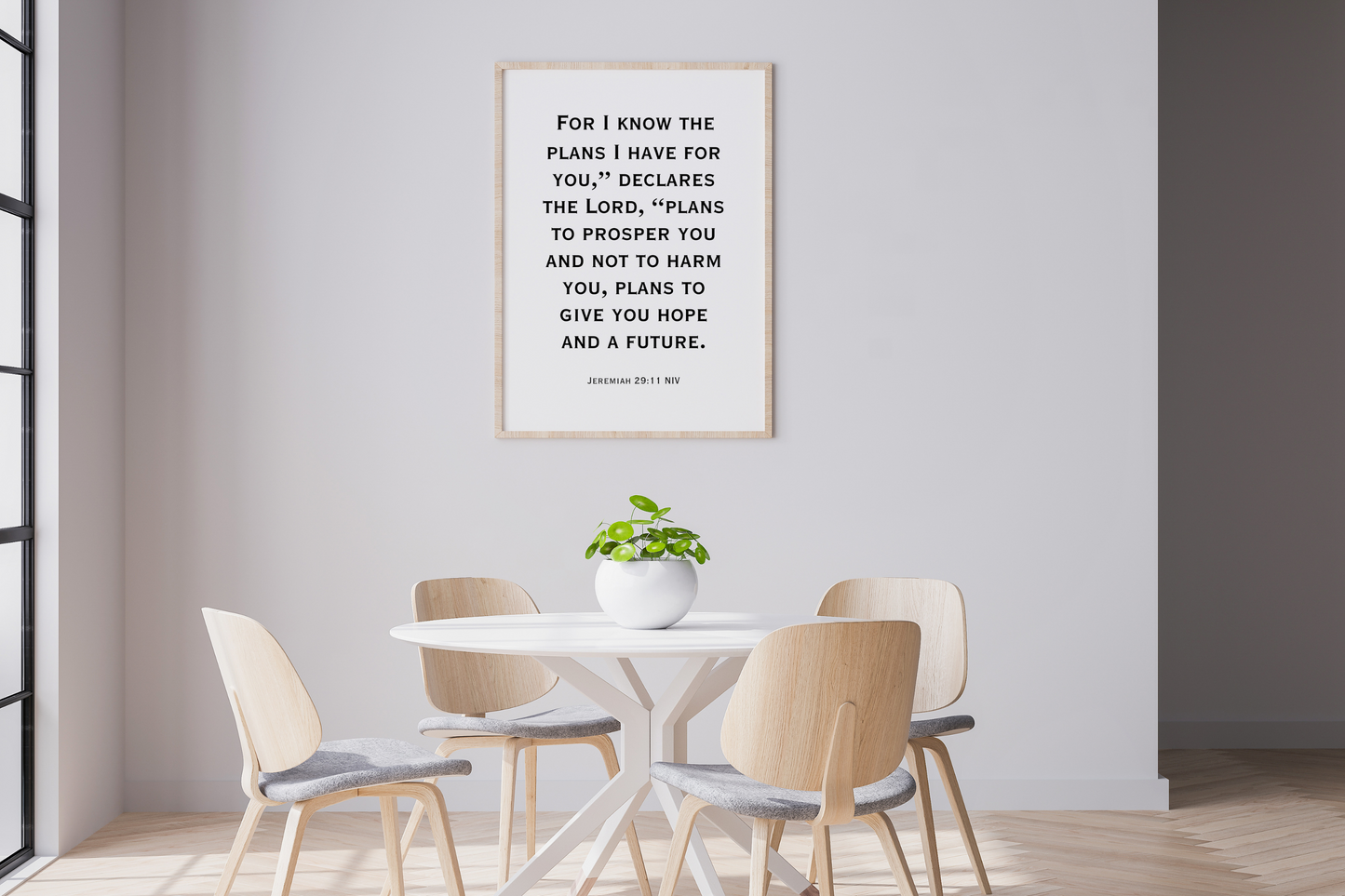 Dining room with a framed Inspirational Christian scripture digital art print of Jeremiah 29:11 on the wall above a table and chairs. styled above a minimalist home dining room.