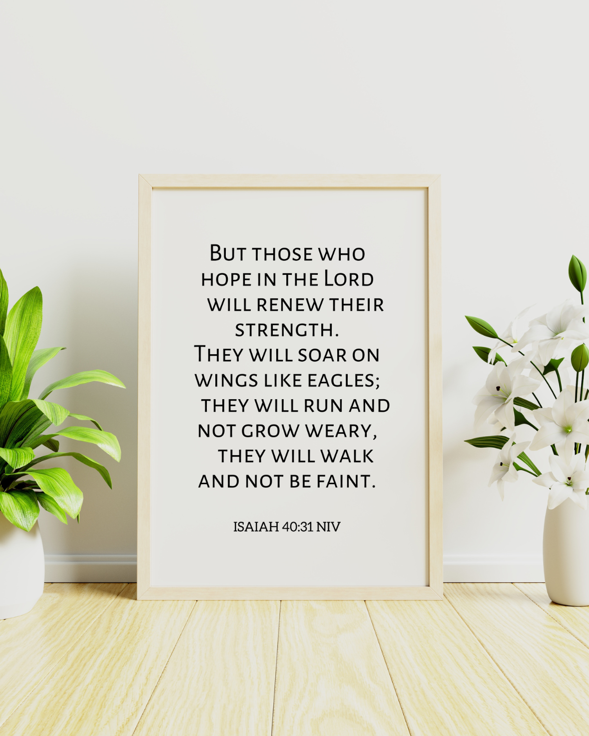 Framed motivational Christian wall decor of Isaiah 40:31 biblical verse, against a white wall with decorative plants.