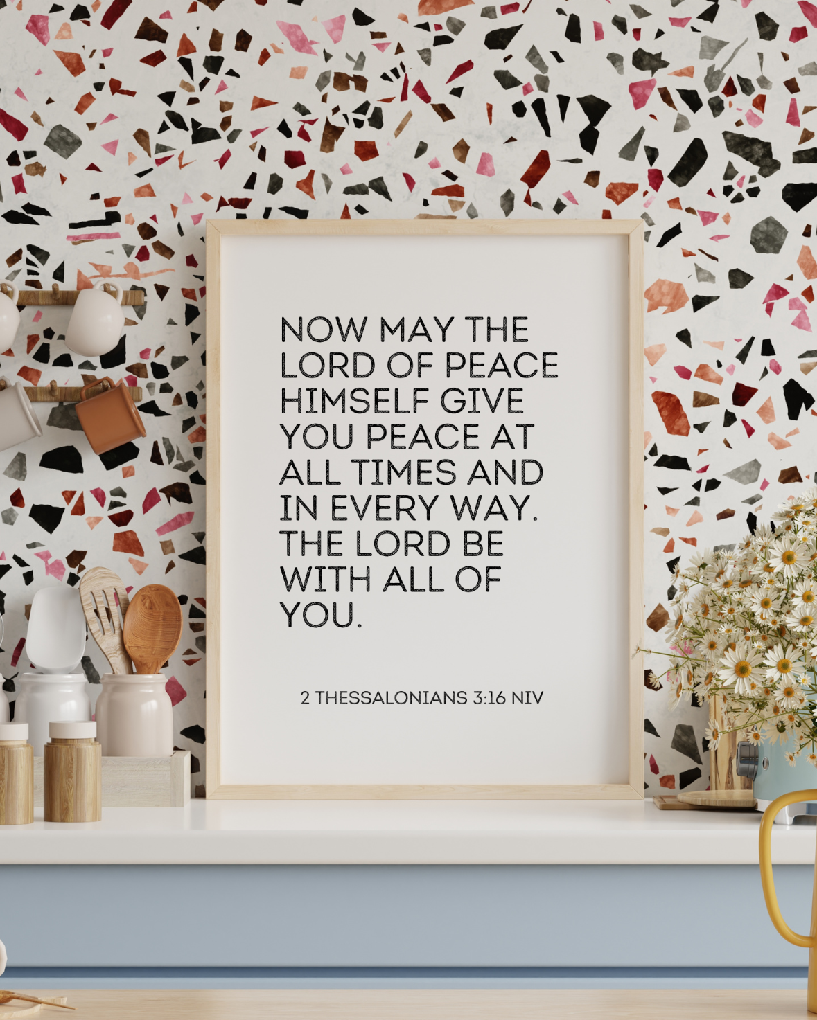 Faith-based printable wall art with 2 Thessalonians 3:16 shown in a trendy modern kitchen.