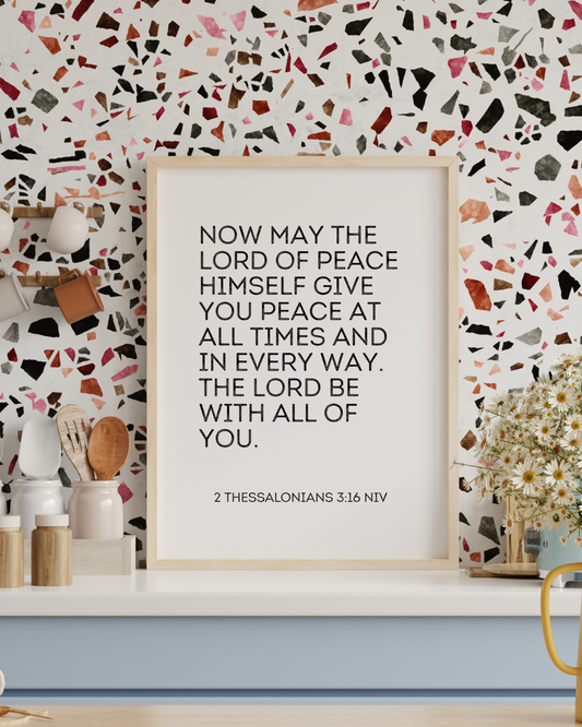 Faith-based printable wall art with 2 Thessalonians 3:16 shown in a trendy modern kitchen.