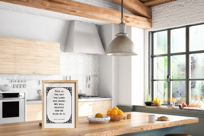 Motivational Christian wall decor of Psalm 118:24 displayed in a bright modern kitchen with a wooden countertop. 