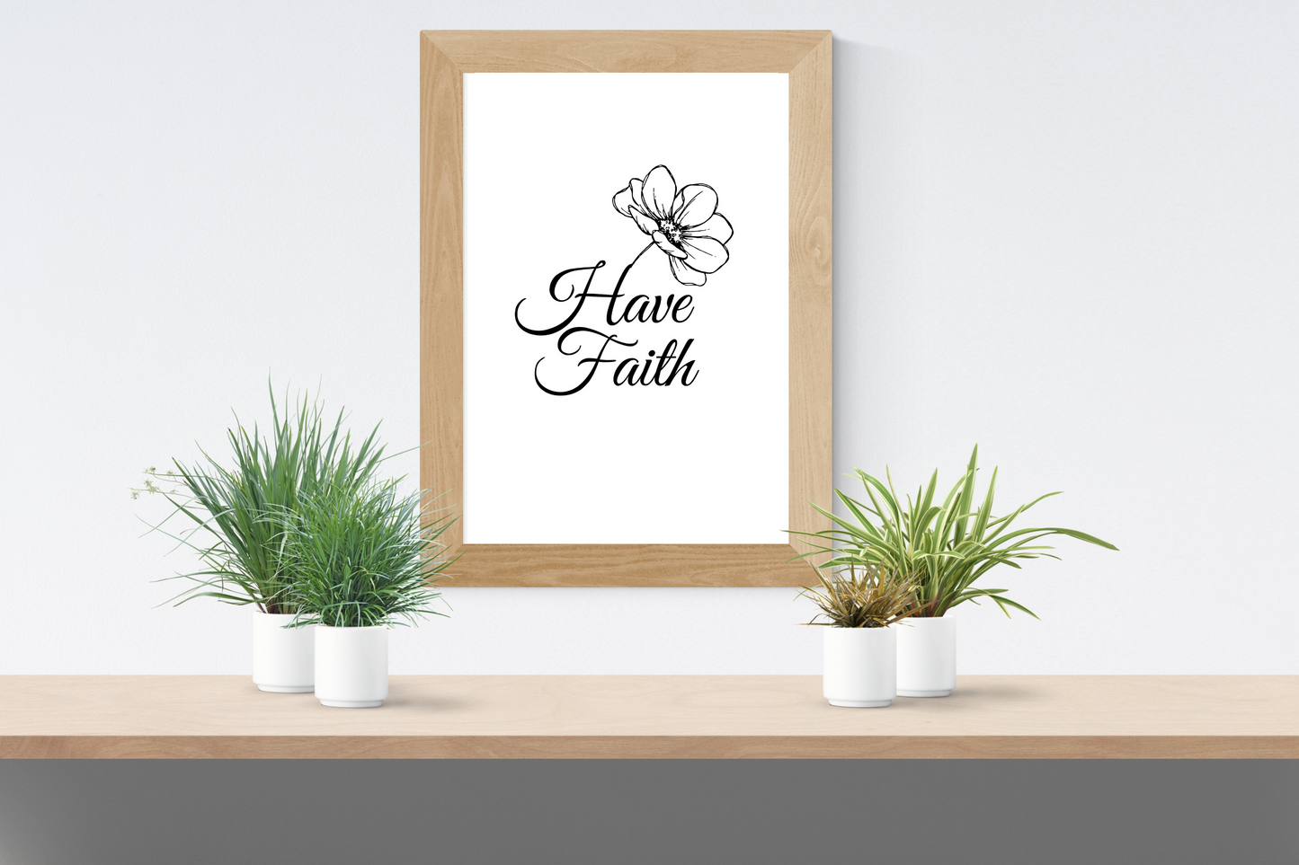 Minimalist Have Faith typography print framed above a shelf in a clean contemporary home interior