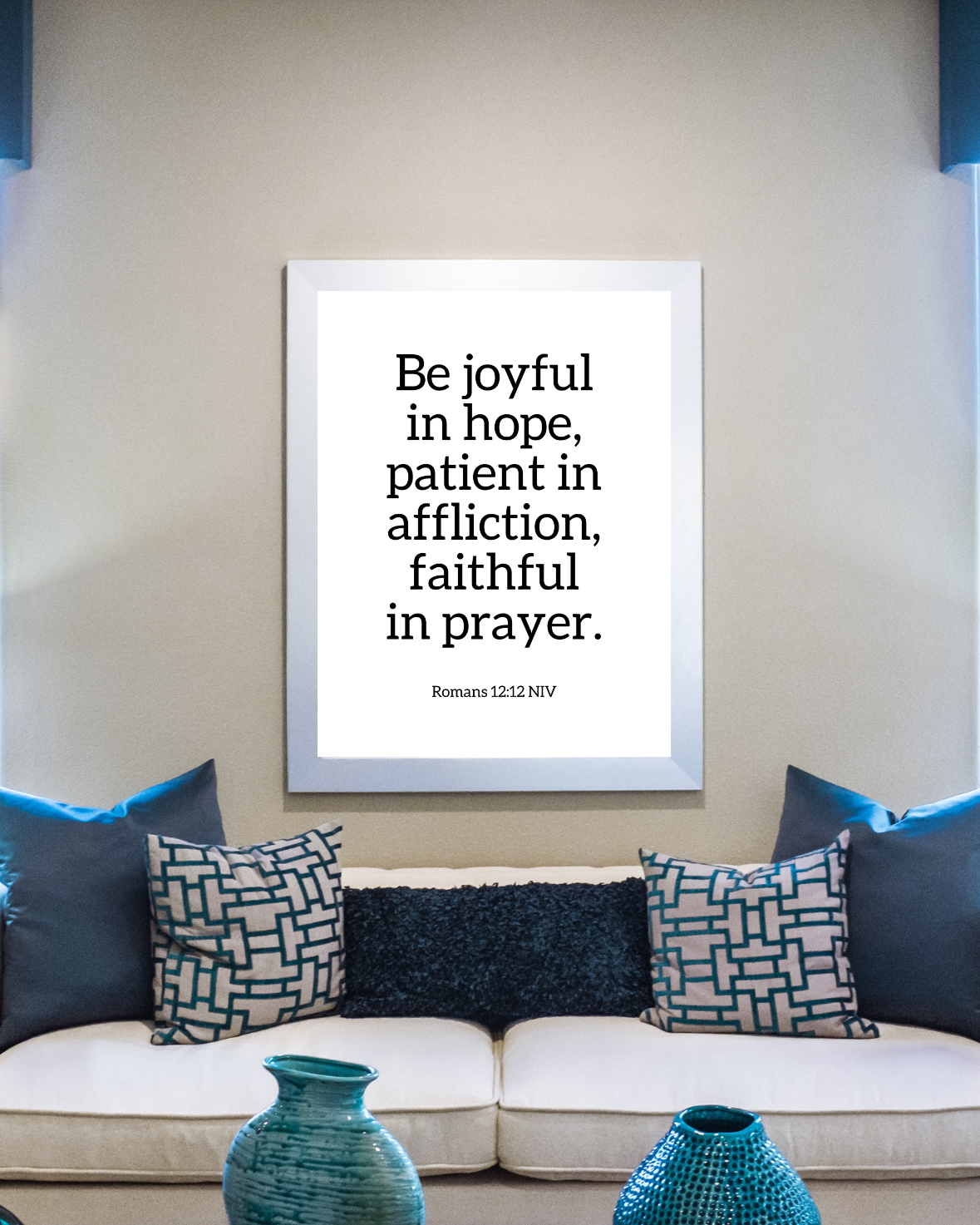 Motivational Christian wall decor of Romans 12:12 displayed in a living room setting with neutral and blue tones. 