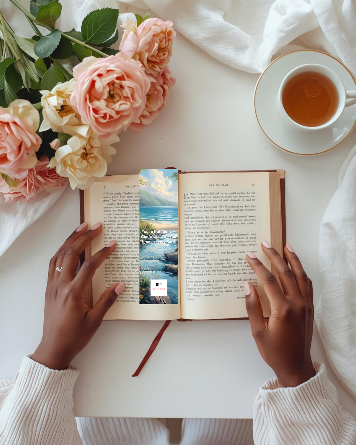 Faith-based printable bookmark inside a reading book with calming natural lighting and a cup of tea.