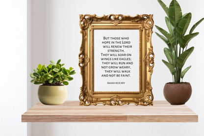 Decorative shelf with gold-framed print, potted plants, and a white wall background. The print is a high-definition scripture wall art printable of Isaiah 40:31.